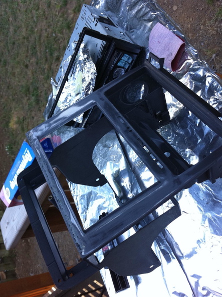 I chipped out the remains of the old epoxy at the top of the screen.
I then sanded back the paint, smeared in the new epoxy.
After the new epoxy hardened I hit it with the sandpaper to flatten it out.
The old epoxy was thin and pooled where it sat. This stuff more or less held a shape while curing. NewEpoxySanded.jpg