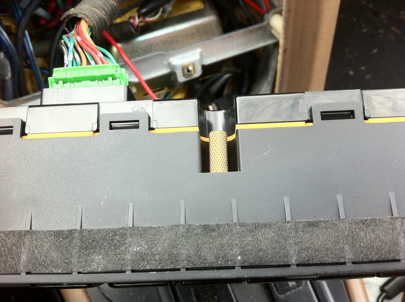 The gold colored metal insert in the center of this photo is normally embedded in the plastic of the dash. One screw threads into it from the front of the control cluster to hold them in the dash.
Prying these controls out by force ripped the insert out of the dash. I was able to shove it back into the dash with a little force and some epoxy, holds the controls as if nothing happened. ThreadedInsert_HDR.jpg