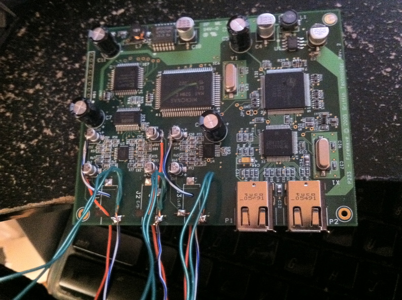 This is the Griffin Firewave after I removed the old headphone jacks. If you look closely at where the left and middle jacks were, a few of the square copper pads they had soldered onto lifted off the PCB during desolder. Each one was traced back to a leg of one of the nearby capacitors, so I was able to solder my new wiring to those instead.
GFRewiredAbv_HDR.jpg